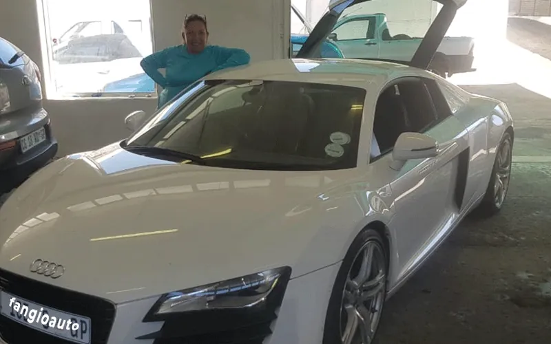 Alejandra at the wheel of a white Audi R8 in the Randburg workshop