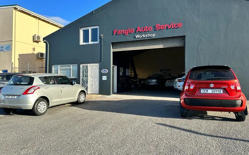 The Fangio Auto Hermanus workshop building with customer cars parked outside