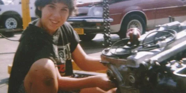 A young Miguel rebuilding an engine on a bench, long before Fangio Auto opened