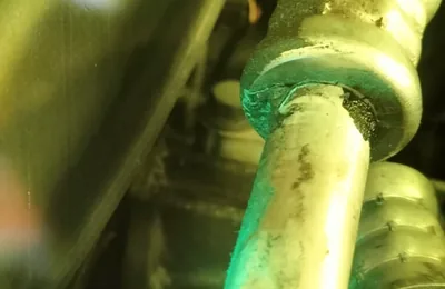 UV dye showing an aircon gas leak at a pipe fitting
