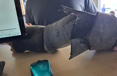 Old air suspension bellow removed from a car, split along its fold