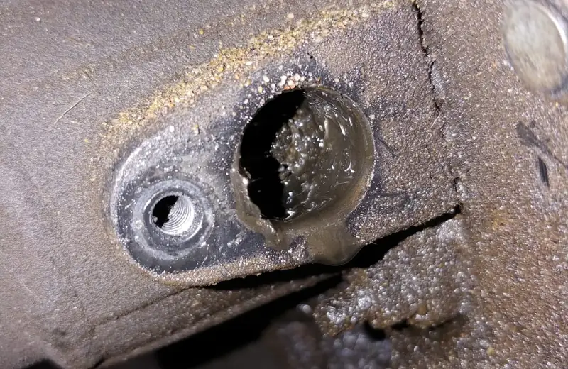 Corroded ABS wheel speed sensor mounting on a wheel hub being inspected at Fangio Auto Hermanus