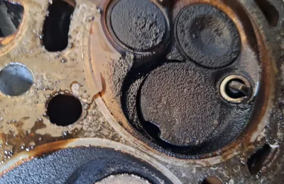Cylinder head face showing carbon and burnt deposits