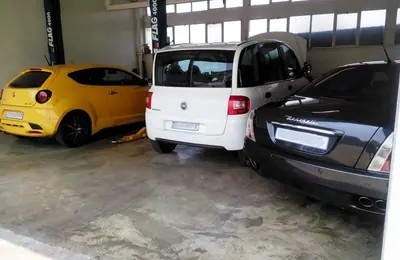 Vehicles being inspected in the Fangio Auto workshop