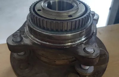 Used wheel hub with the bearing visible on the workshop floor