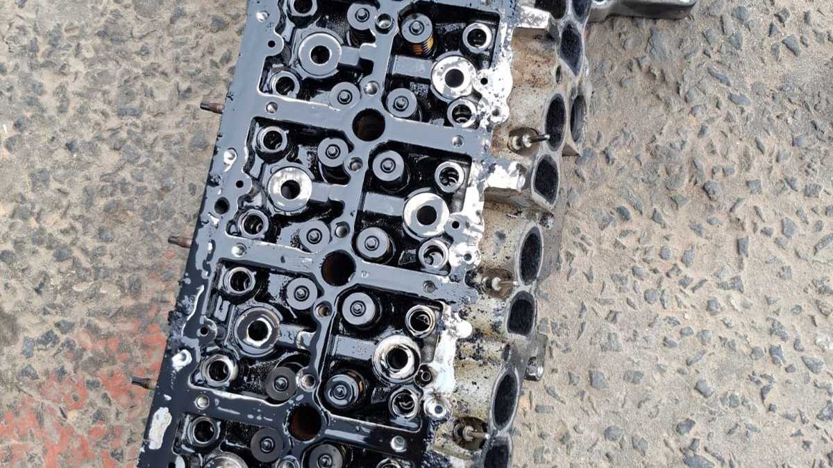Cylinder head removed with the camshafts out on the workshop floor