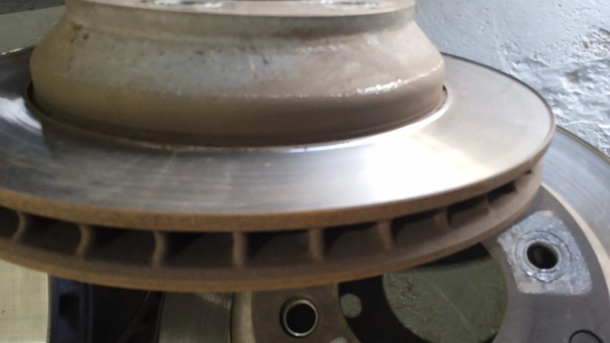 Rusty brake disc and hub assembly removed from a car