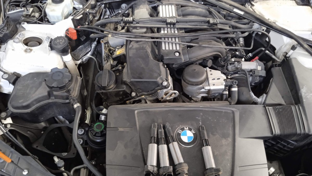 BMW engine bay with ignition coils out during a service