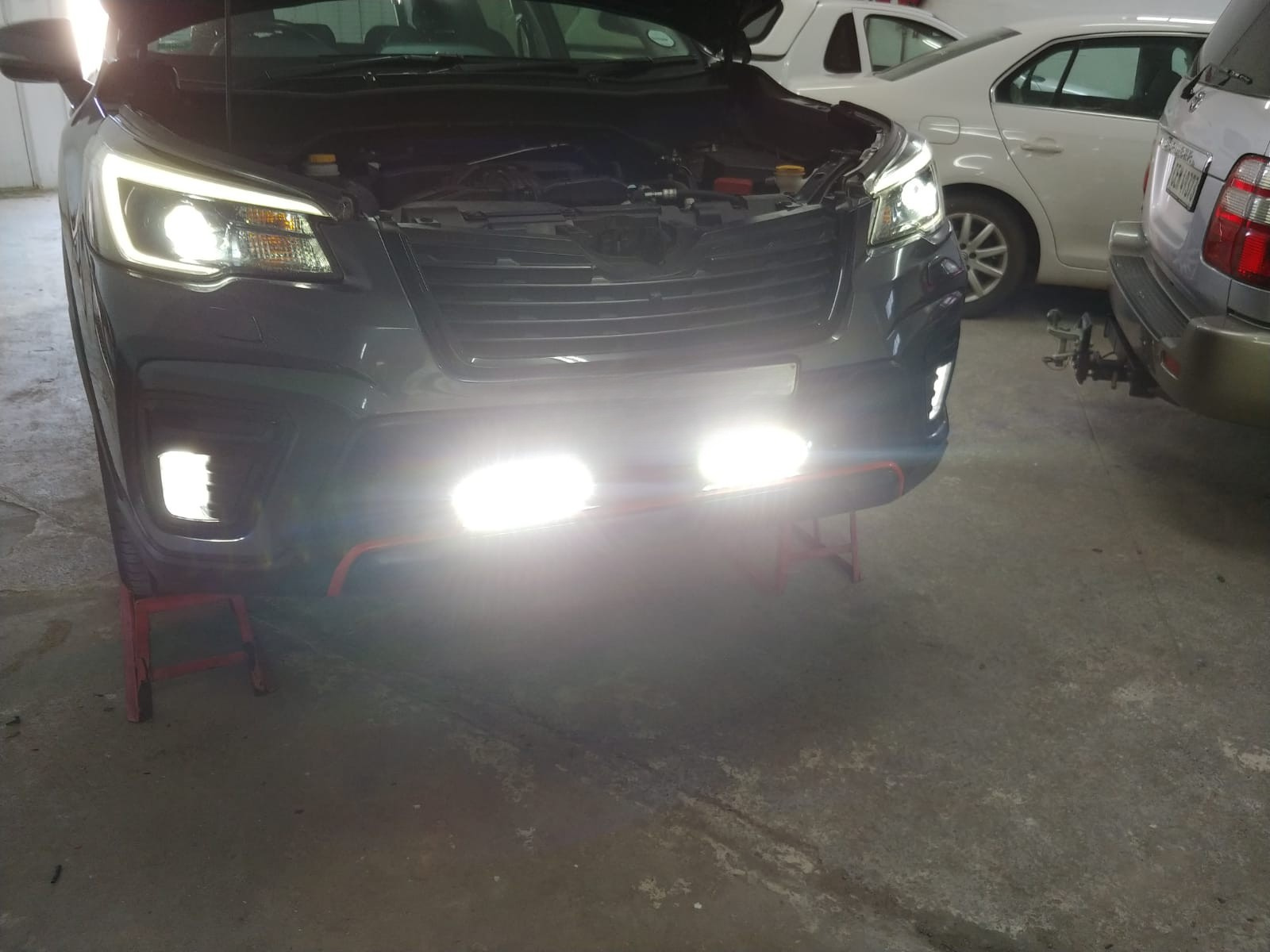 Auto electrician testing LED light bars on a Subaru Forester in Hermanus
