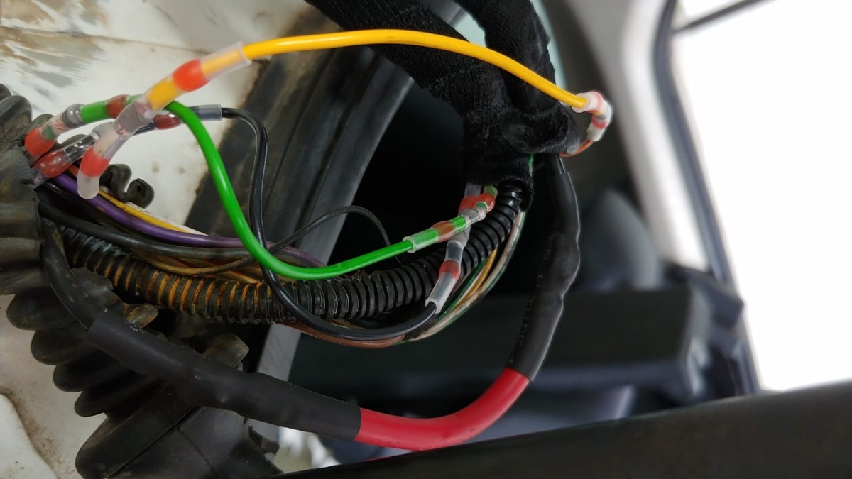Auto electrician in Hermanus repairing a boot lock wiring loom with heat shrink connectors