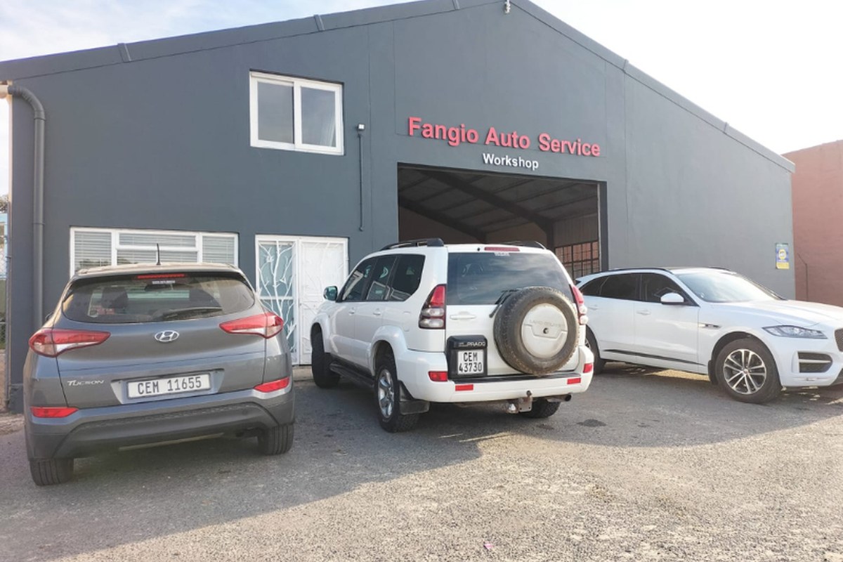 Fangio Auto Service workshop in Hermanus with cars parked outside