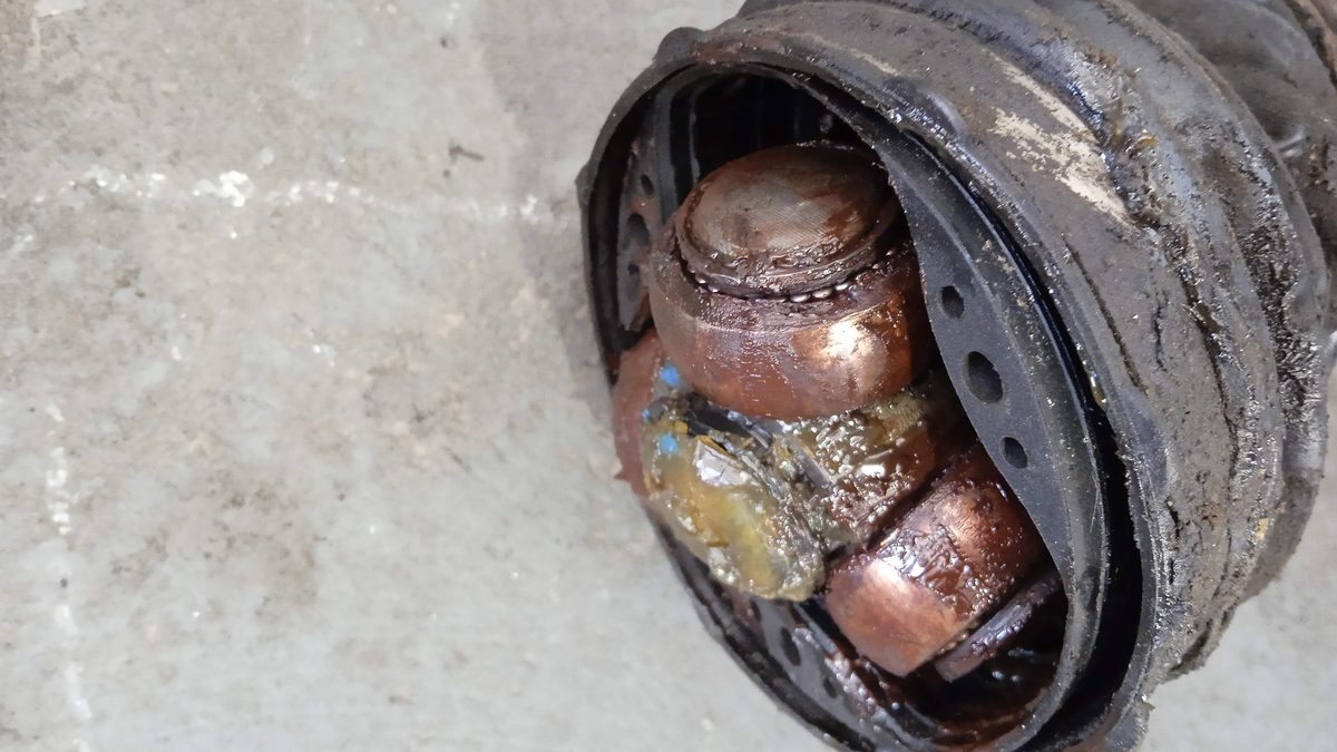 Failed CV joint with dirty contaminated grease after the boot tore