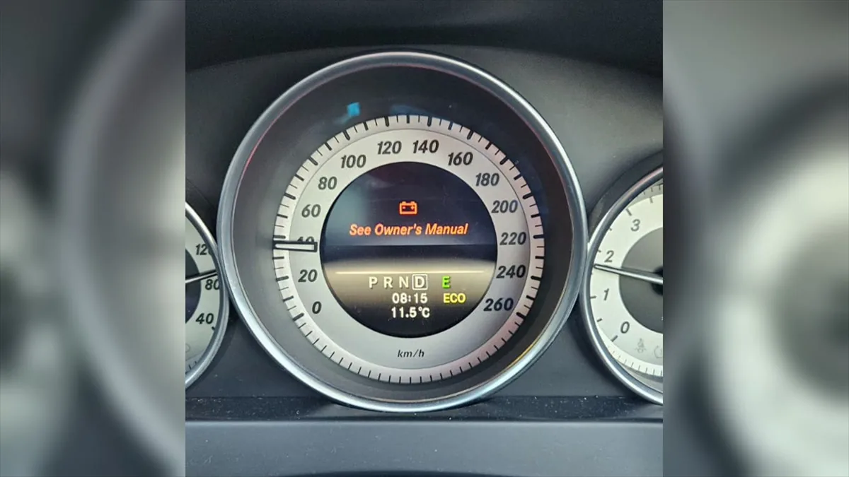 Mercedes C180 instrument cluster showing a red battery warning and See Owner's Manual message