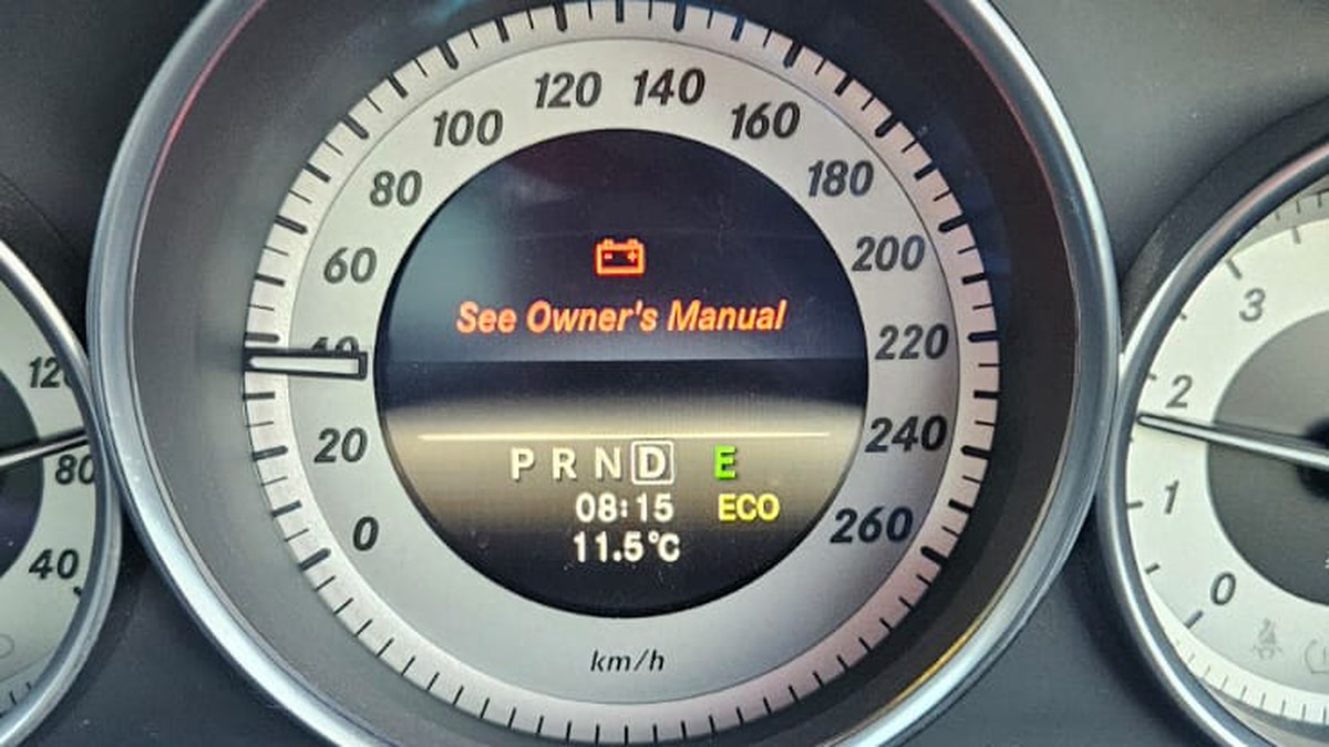 Red battery warning light and See Owner's Manual message on a Mercedes C-Class instrument cluster