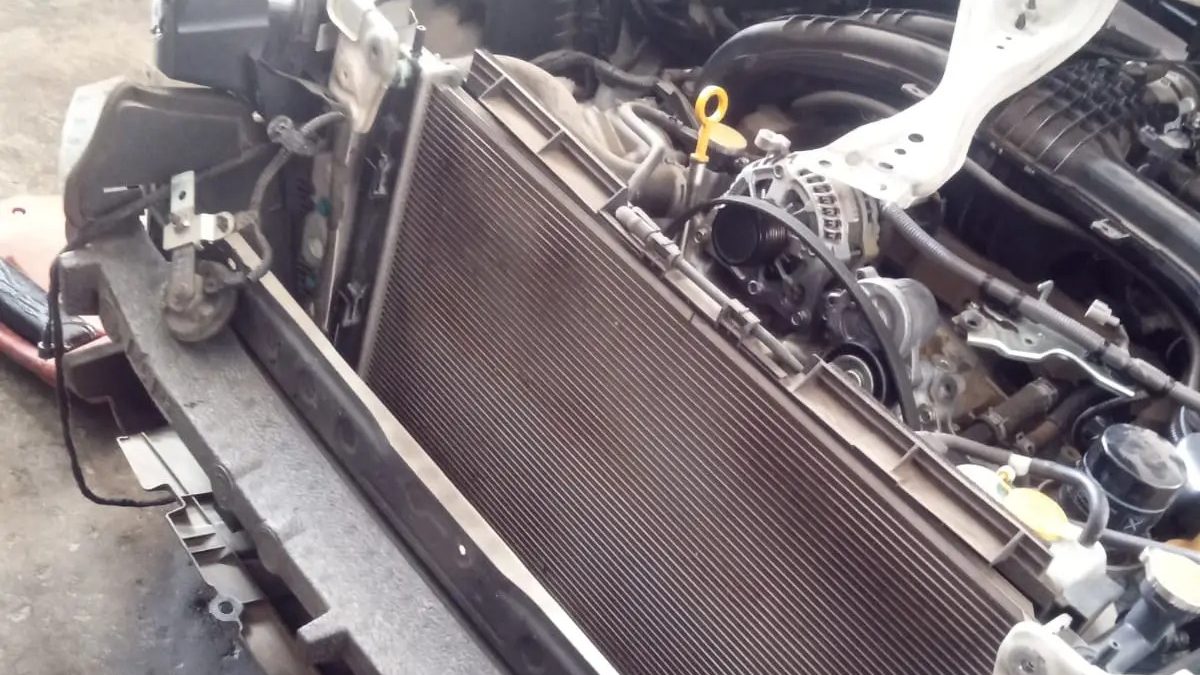 Radiator and condenser exposed with the front bumper removed
