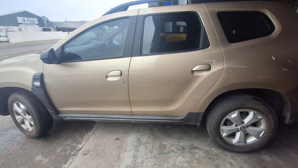A gold Renault Duster parked outside the Fangio Auto Service workshop in Hermanus Industrial.