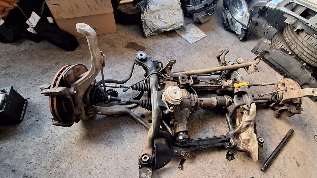 Front subframe with steering rack, drive shafts and hubs removed from a car