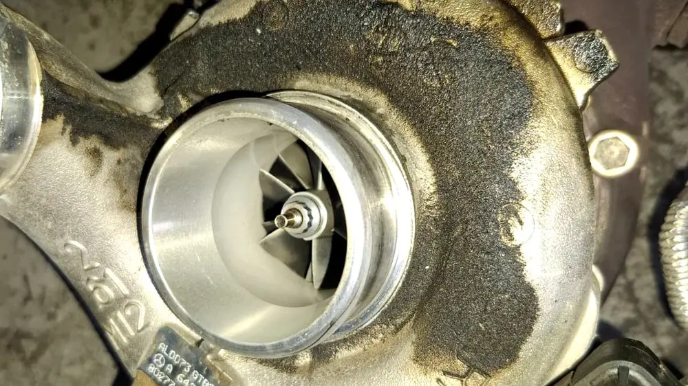 Oil and carbon build-up on the compressor housing of a failed Mercedes turbocharger