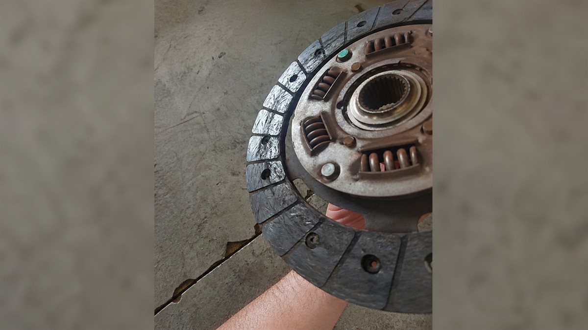 Glazed and scored friction lining on a worn clutch disc